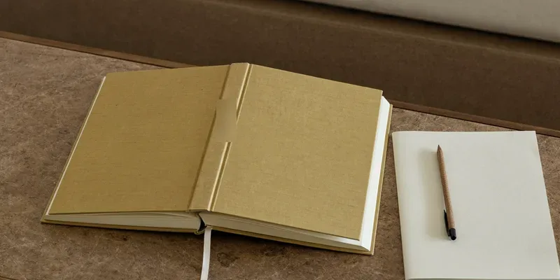 Thick mustard book with notebook and pen