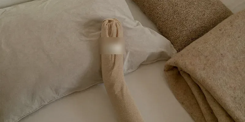 Elastic support wrap beside a fabric warmth pillow