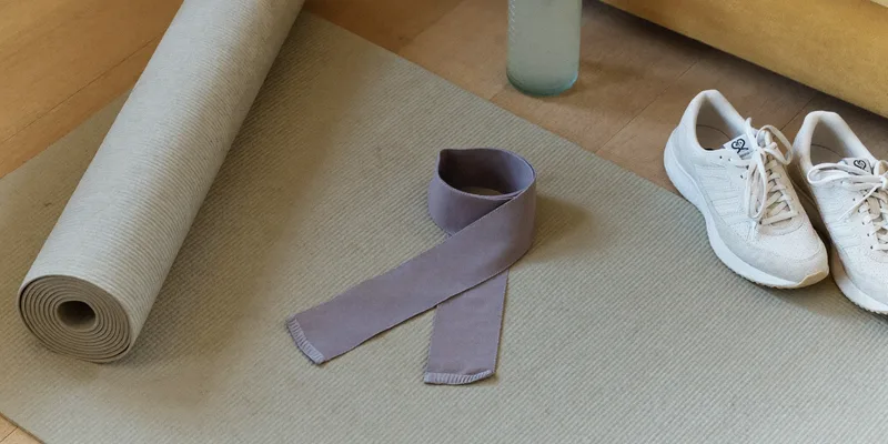 Fabric band on a yoga mat with sneakers