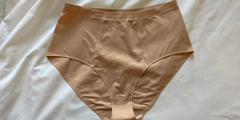 High waist support briefs laid flat on bedding