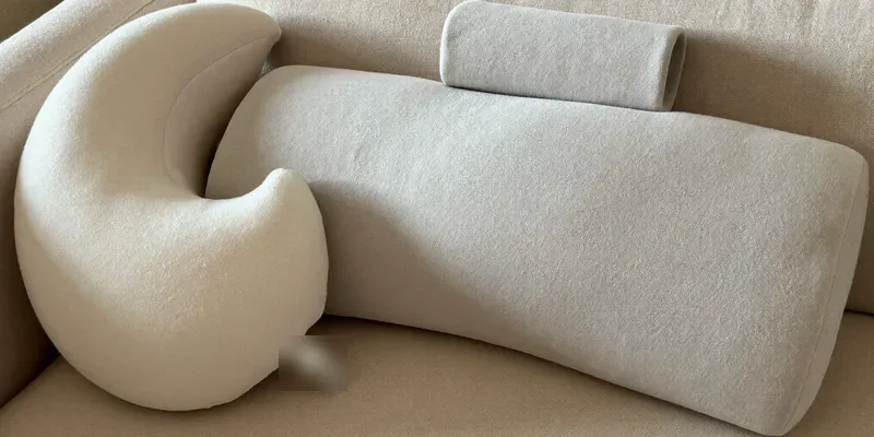 Curved nursing pillow beside a flat topped one