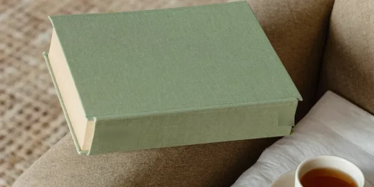 Sage green book seen from the side with tea