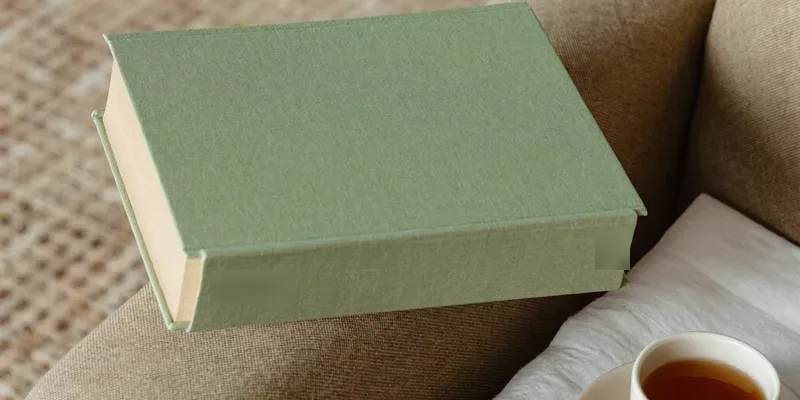 Sage green book seen from the side with tea