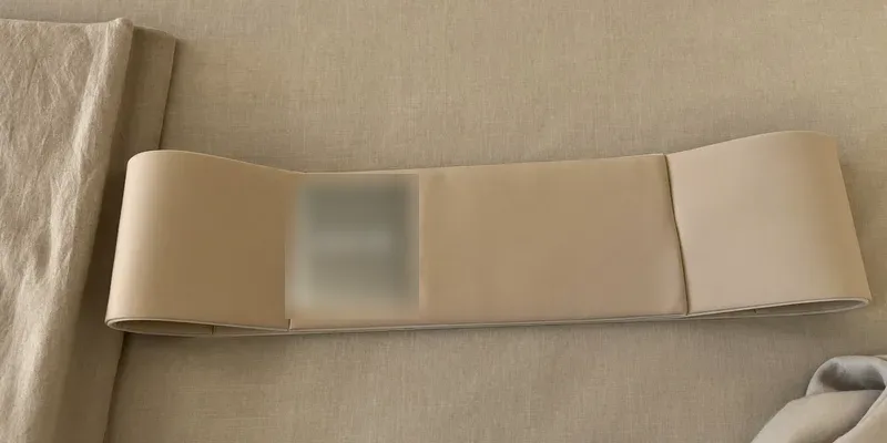 Wide soft support belt laid flat on bedding