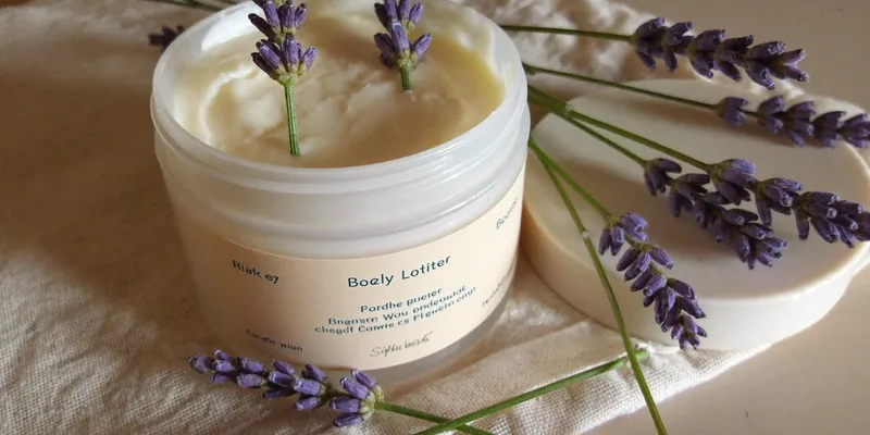 Plain white jar of body butter with lavender sprigs
