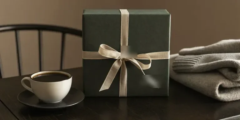 Green wrapped gift with coffee and a sweater