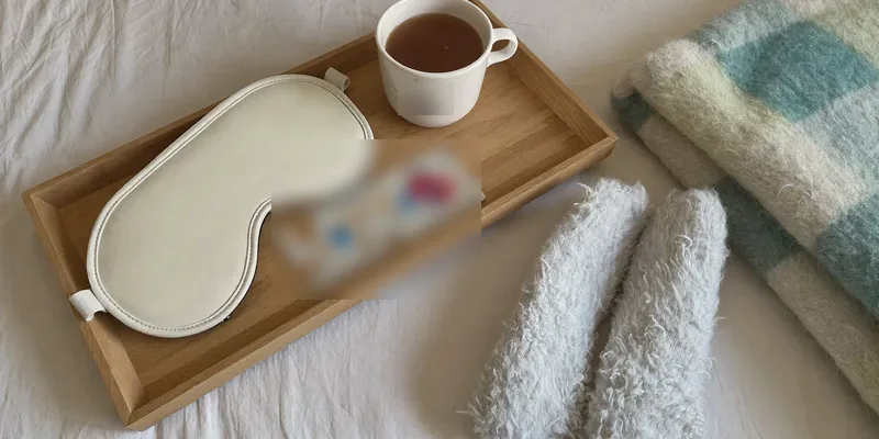 Bed tray with tea, eye mask, socks and puzzle
