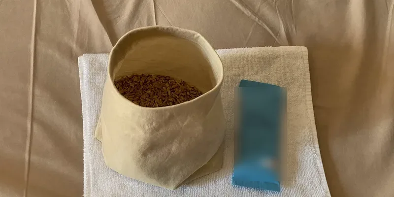 Wheat pouch and blue gel pack on a folded towel