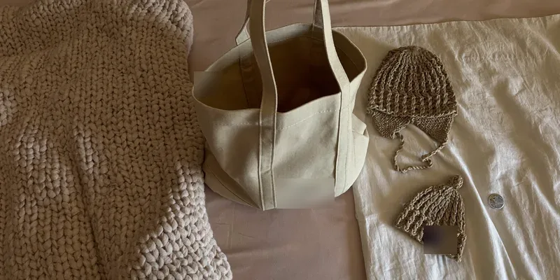 Bag with winter knits on one side and summer items on the other
