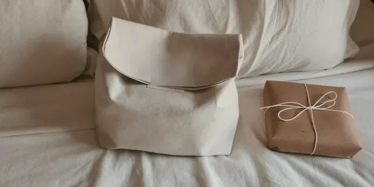 Compact canvas bag beside a plain wrapped gift