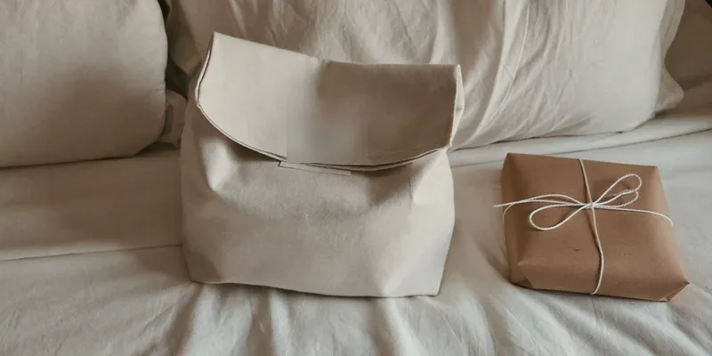 Compact canvas bag beside a plain wrapped gift