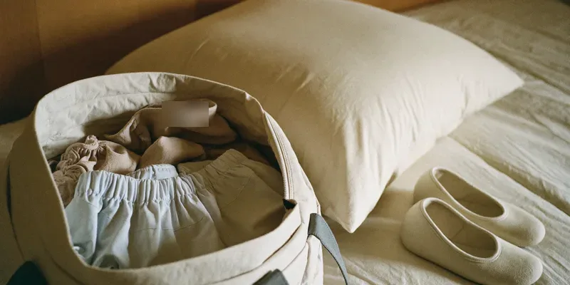Soft bag packed with loose clothing and slip-ons