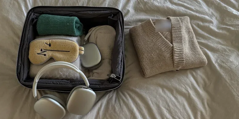 Bag packed with socks, eye mask and headphones