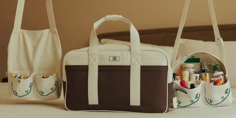 Weekender bag beside a hanging toiletry bag