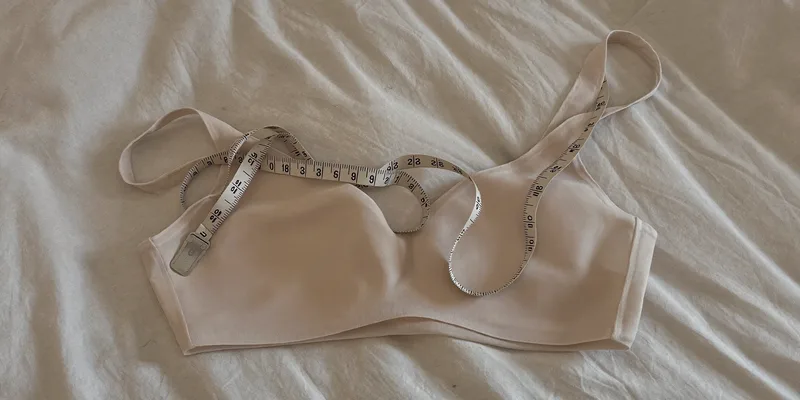 Soft bra with a fabric measuring tape coiled around it