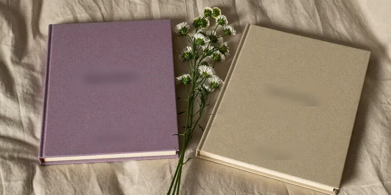 Two plain books with dried flowers between them