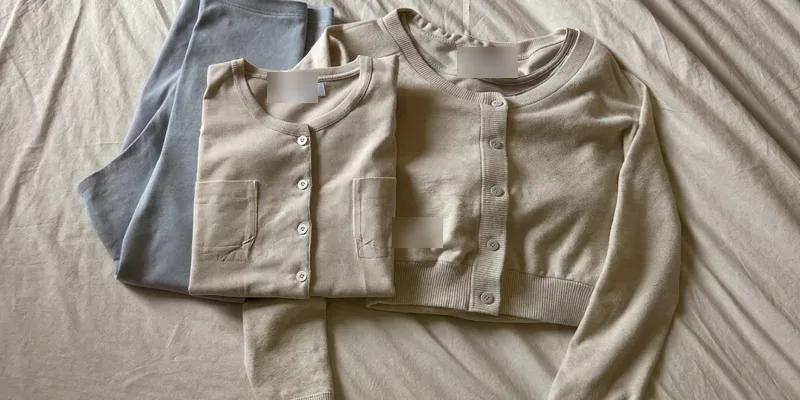 Small pile of folded neutral maternity clothing