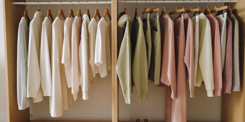Clothing rack with soft garments on wooden hangers