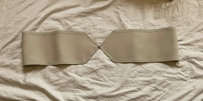 Wide beige maternity support belt laid flat