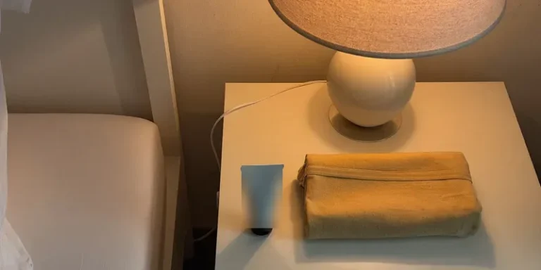Small white tube of cream on a nightstand