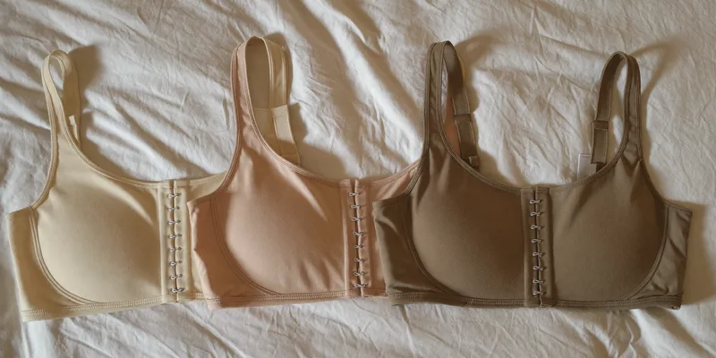 Three soft nursing bras laid flat in a row