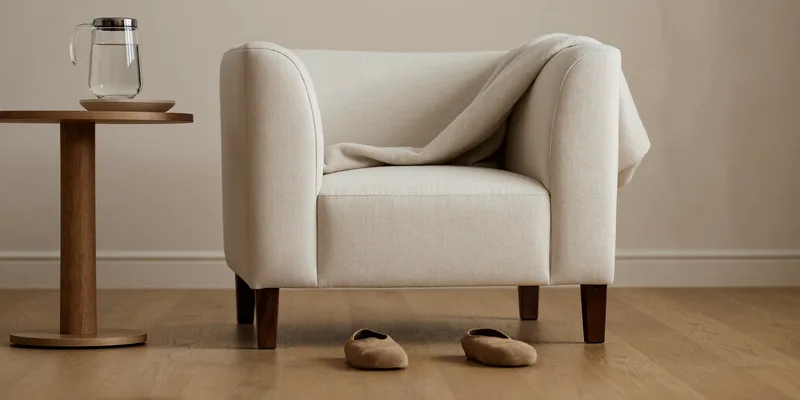 Armchair with footstool and side table in a nursery