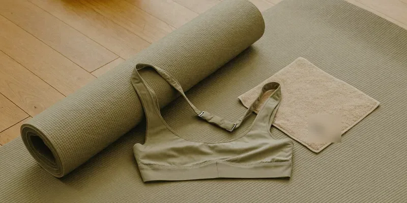 Sports bra with front clips on a rolled yoga mat