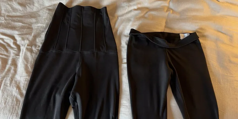 Two black leggings with different waist panel heights