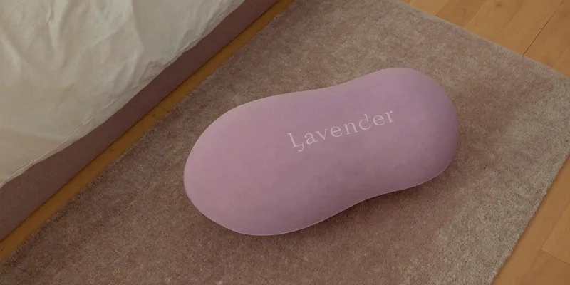 Lavender peanut shaped exercise ball on a rug