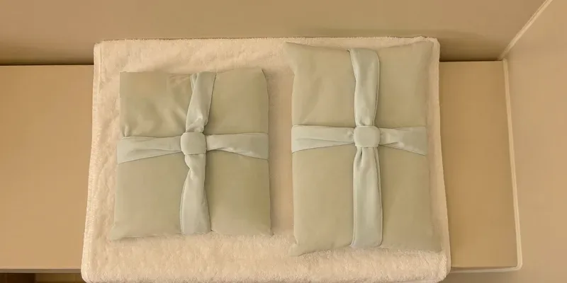 Two fabric covered cooling packs on a towel