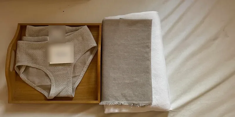 Stack of soft mesh briefs on a wooden tray