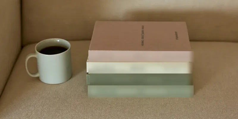 Stack of three plain books on a reading chair