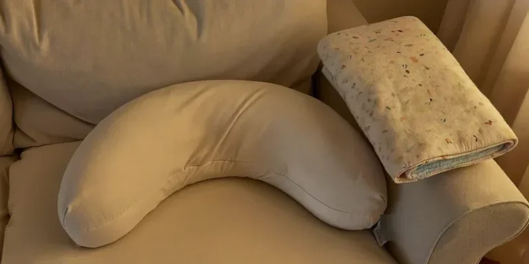 Curved pillow used as lounging support on a sofa