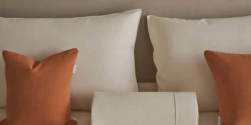 Back cushion and bolster roll against a headboard
