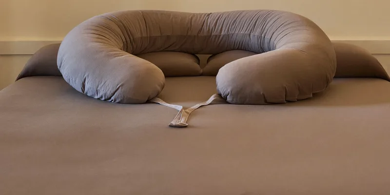 Extra wide U-shaped pregnancy pillow on a king bed