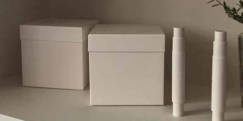 Two blank white boxes with plain white sticks