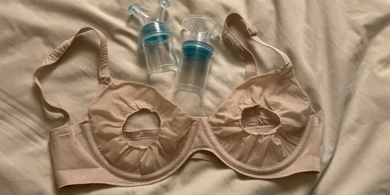 Pumping bra beside two pump funnels in different sizes
