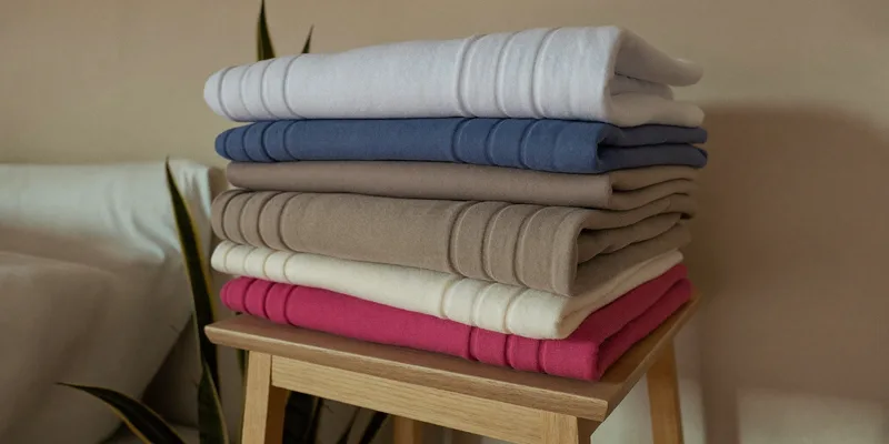 Stack of folded seamless nursing bras on a shelf