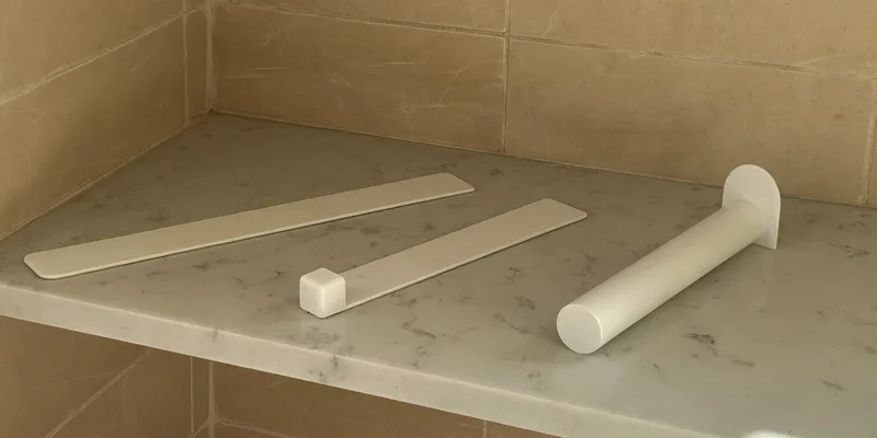 Three plain white stick shapes on a marble shelf