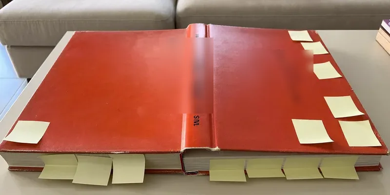 Thick well-used book with colorful sticky tabs