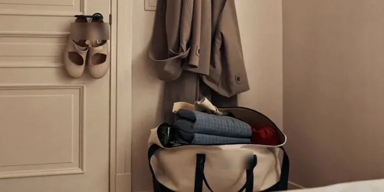 Packed weekender bag ready by the bedroom door