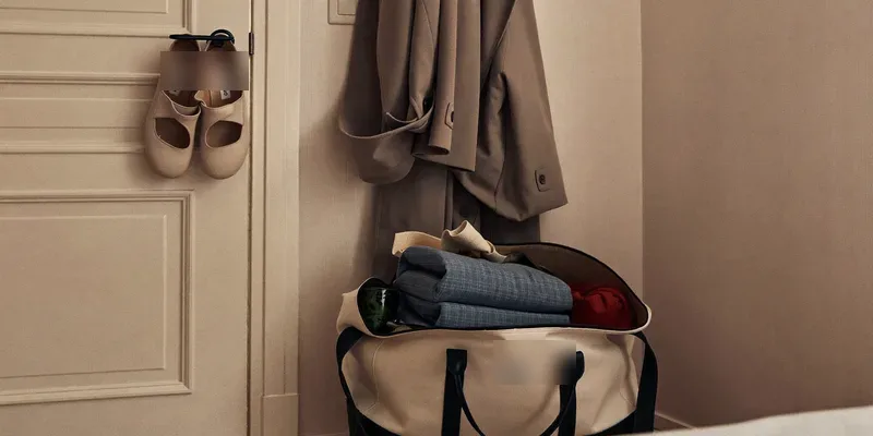 Packed weekender bag ready by the bedroom door